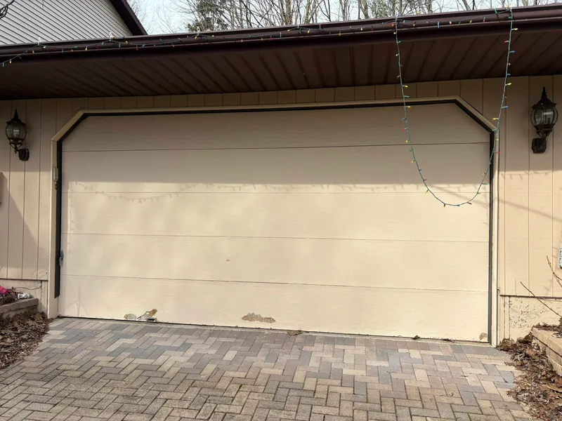 Before — worn garage door before replacement